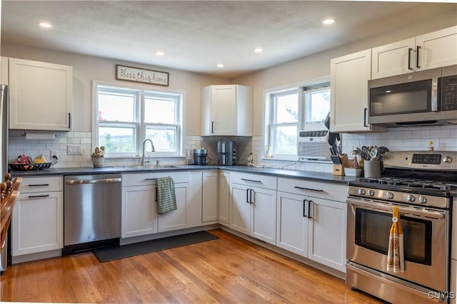 4045 E Milestrip Rd, Fenner, NY 13032 - kitchen with appliances with stainless steel finishes, healthy amount of natural light, dark countertops, tasteful backsplash, and recessed lighting