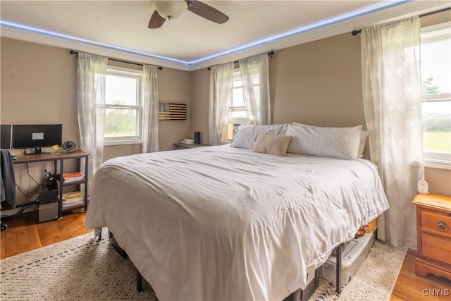 4045 E Milestrip Rd, Fenner, NY 13032 - bedroom featuring multiple windows, wood finished floors, ceiling fan, and a desk