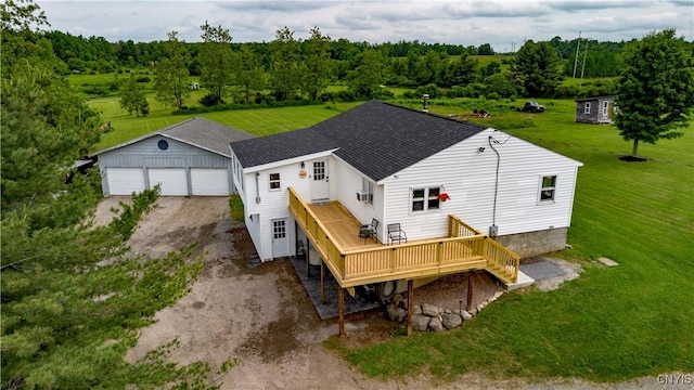 4045 E Milestrip Rd, Fenner, NY 13032 - rear view of house featuring a wooden deck, a shingled roof, an outdoor structure, a garage, and a yard