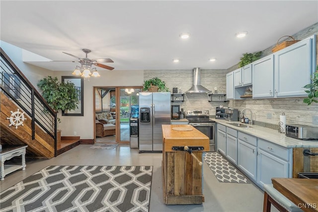 2012 Pleasant Ave, Vienna, NY 13308 - kitchen with stainless steel appliances, wall chimney range hood, backsplash, concrete flooring, and ceiling fan