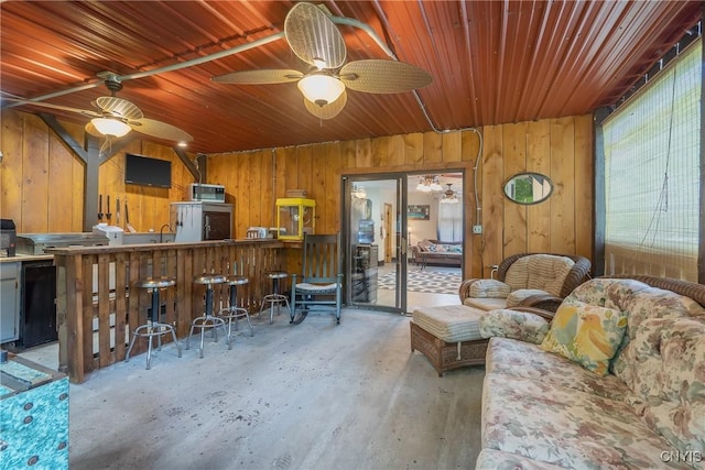2012 Pleasant Ave, Vienna, NY 13308 - living room featuring wooden walls, wood ceiling, and a ceiling fan