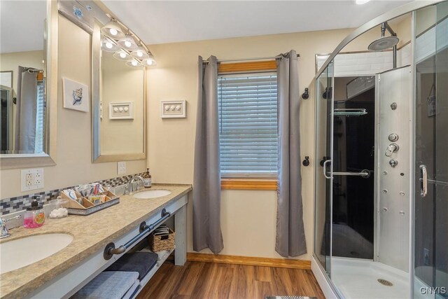 2012 Pleasant Ave, Vienna, NY 13308 - bathroom with wood finished floors, double vanity, and a stall shower