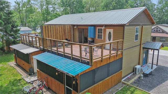 2012 Pleasant Ave, Vienna, NY 13308 - back of property with a metal roof and view of wooded area