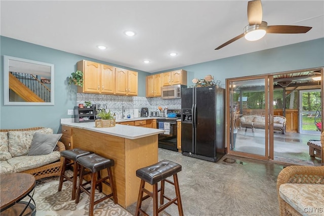 2012 Pleasant Ave, Vienna, NY 13308 - kitchen featuring black appliances, light brown cabinets, a kitchen breakfast bar, open floor plan, and recessed lighting