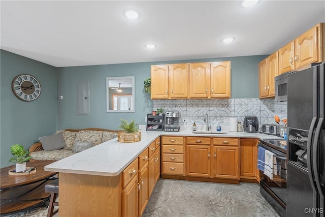2012 Pleasant Ave, Vienna, NY 13308 - kitchen with black appliances, light countertops, a peninsula, a breakfast bar, and tasteful backsplash