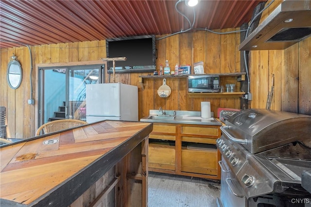 2012 Pleasant Ave, Vienna, NY 13308 - kitchen featuring stainless steel microwave, freestanding refrigerator, ventilation hood, wood walls, and wood ceiling