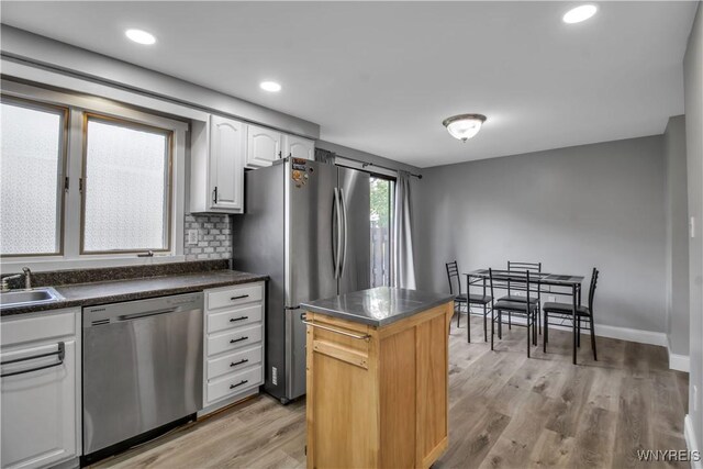 351 Charlesgate Cir, Amherst, NY 14051 - kitchen with stainless steel appliances, white cabinetry, dark countertops, light wood-style flooring, and a center island