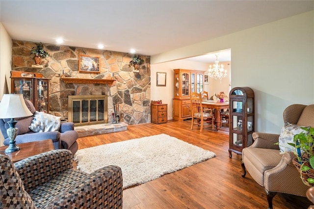 99 Old English Dr, Greece, NY 14616 - living room featuring a chandelier, wood finished floors, and a fireplace