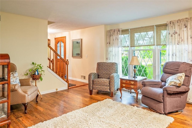 99 Old English Dr, Greece, NY 14616 - living area featuring wood finished floors and stairs