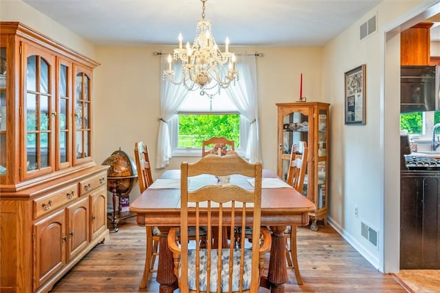 99 Old English Dr, Greece, NY 14616 - dining space with a chandelier and wood finished floors
