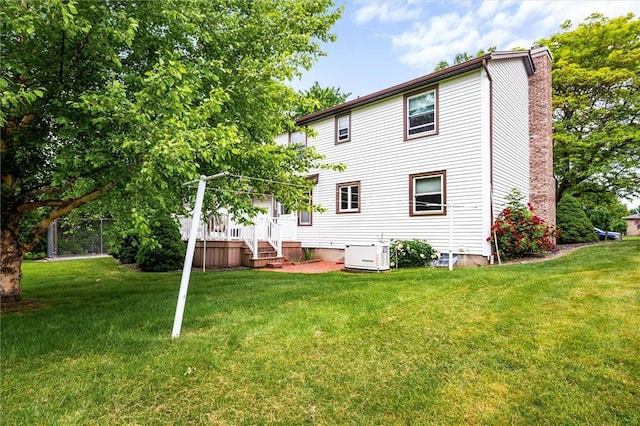 99 Old English Dr, Greece, NY 14616 - rear view of house with a chimney and a lawn