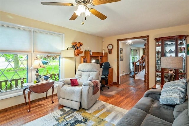 99 Old English Dr, Greece, NY 14616 - living area featuring wood finished floors, stairway, and a ceiling fan