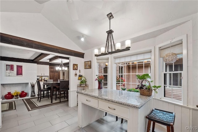 4582 Whetstone Rd, Manlius, NY 13104 - kitchen featuring a chandelier, vaulted ceiling, white cabinetry, and hanging light fixtures