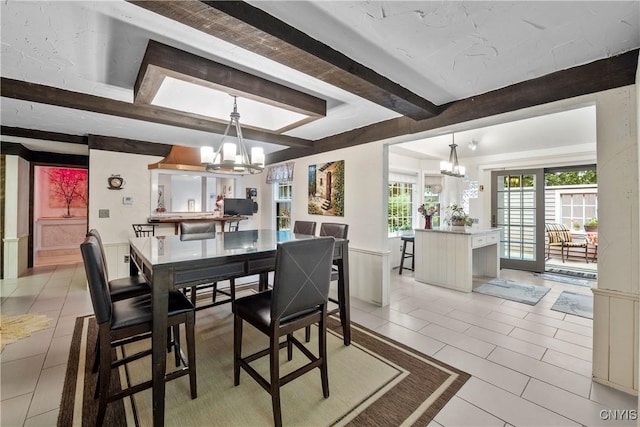 4582 Whetstone Rd, Manlius, NY 13104 - dining space featuring a chandelier, beam ceiling, and light tile patterned floors