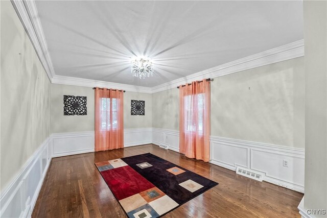 4582 Whetstone Rd, Manlius, NY 13104 - unfurnished room with wood finished floors, a chandelier, ornamental molding, wainscoting, and a decorative wall