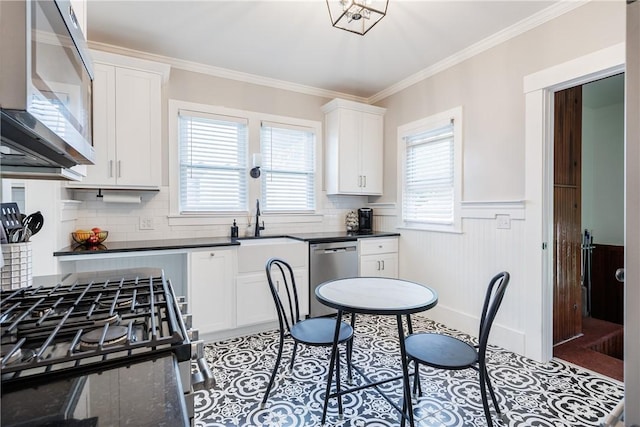 905 W Center St, Ridgeway, NY 14103 - kitchen featuring appliances with stainless steel finishes, wainscoting, crown molding, white cabinetry, and backsplash