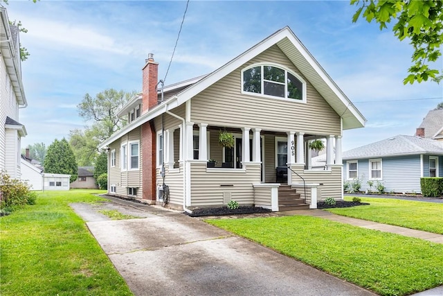 905 W Center St, Ridgeway, NY 14103 - view of front facade featuring a chimney, a porch, a front lawn, and driveway