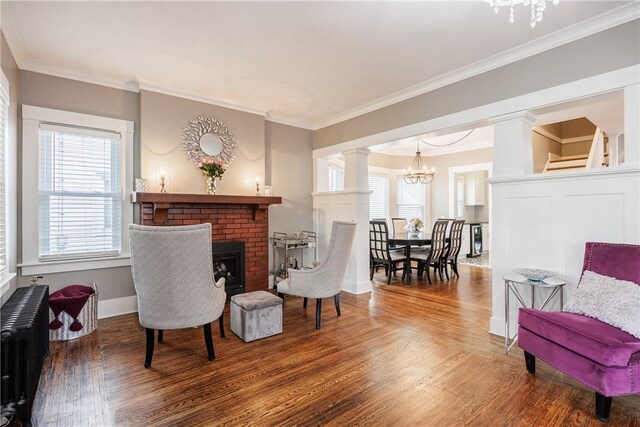 905 W Center St, Ridgeway, NY 14103 - sitting room featuring radiator heating unit, wood finished floors, a chandelier, plenty of natural light, and crown molding