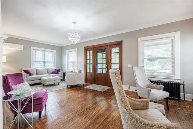 905 W Center St, Ridgeway, NY 14103 - living area featuring radiator, a wall mounted AC, ornamental molding, wood finished floors, and a chandelier