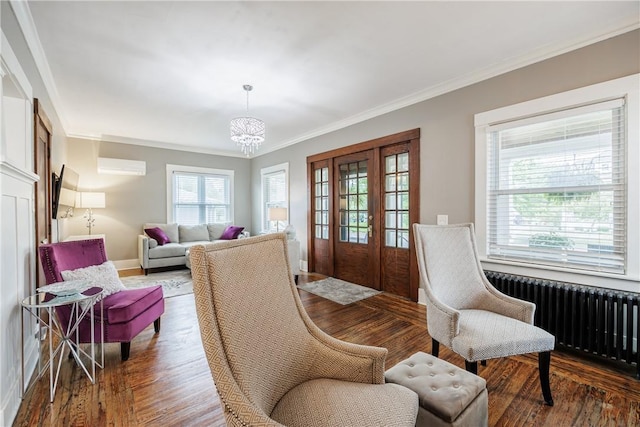 905 W Center St, Ridgeway, NY 14103 - living area featuring radiator, crown molding, a chandelier, wood finished floors, and a wall mounted air conditioner