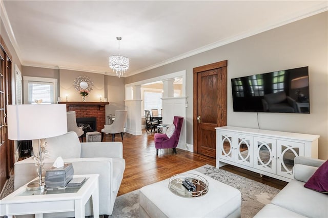 905 W Center St, Ridgeway, NY 14103 - living area featuring ornate columns, wood finished floors, ornamental molding, and a fireplace