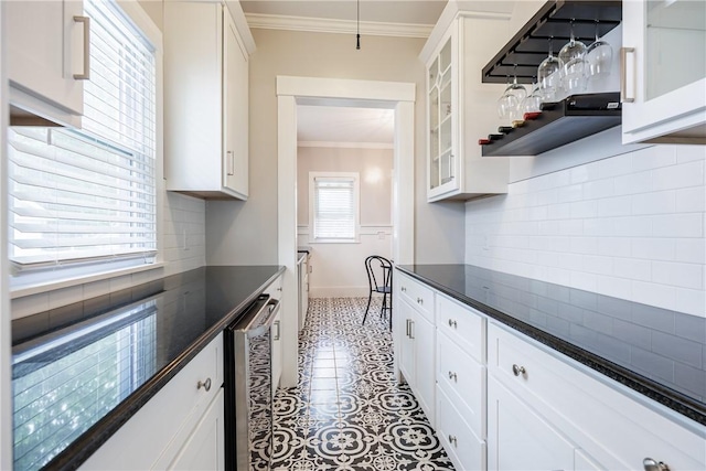 905 W Center St, Ridgeway, NY 14103 - kitchen with ornamental molding, dark countertops, wine cooler, white cabinets, and glass insert cabinets