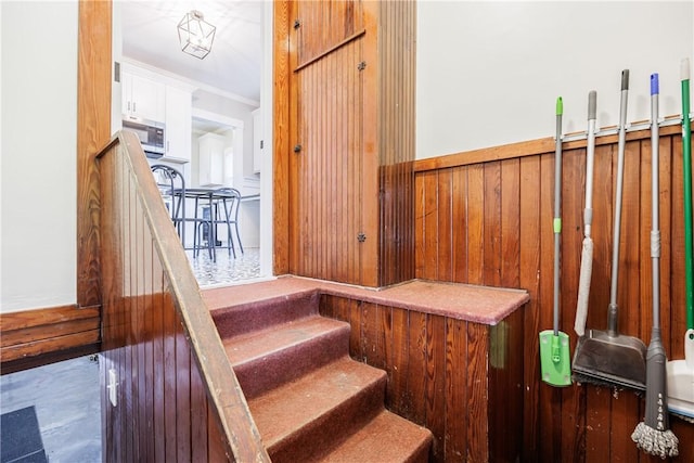 905 W Center St, Ridgeway, NY 14103 - staircase with a wainscoted wall and wooden walls