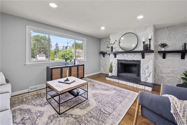 8478 Grandview Dr, Cicero, NY 13039 - living room featuring recessed lighting, a stone fireplace, and wood finished floors