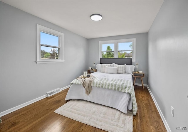 8478 Grandview Dr, Cicero, NY 13039 - bedroom featuring multiple windows and wood finished floors