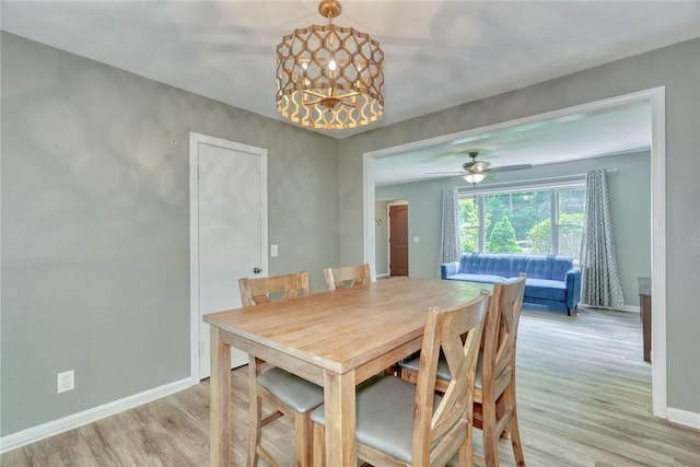 244 Highland Pkwy, Rochester, NY 14620 - dining space featuring light wood-type flooring and a chandelier
