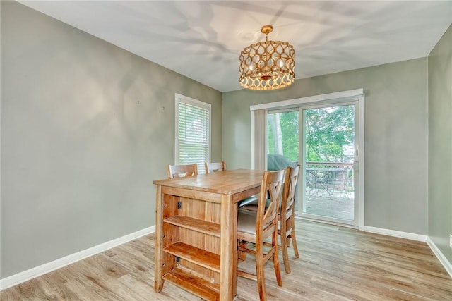 244 Highland Pkwy, Rochester, NY 14620 - dining area featuring light wood-style flooring and a chandelier