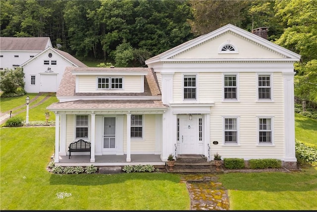 6806 County Highway 14, Meredith, NY 13846 - greek revival inspired property featuring covered porch, a front lawn, roof with shingles, a forest view, and a chimney
