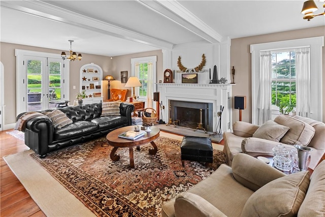 6806 County Highway 14, Meredith, NY 13846 - living area featuring a chandelier, healthy amount of natural light, wood finished floors, a fireplace with raised hearth, and beamed ceiling