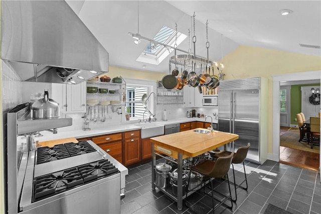 6806 County Highway 14, Meredith, NY 13846 - kitchen with built in appliances, island range hood, lofted ceiling, open shelves, and dark tile patterned floors