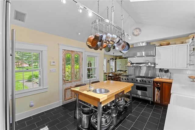 6806 County Highway 14, Meredith, NY 13846 - kitchen with stainless steel appliances, wooden counters, dark tile patterned floors, lofted ceiling, and backsplash