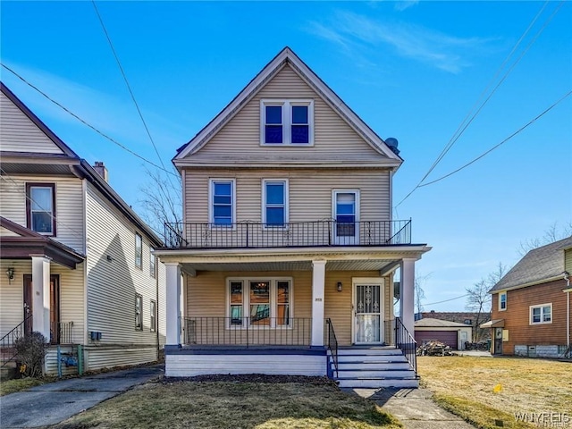 373 Urban St, Buffalo, NY 14211 - american foursquare style home with covered porch, a balcony, and a front lawn