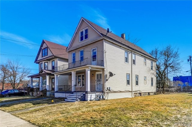 373 Urban St, Buffalo, NY 14211 - view of front of house with a balcony, covered porch, and a front lawn