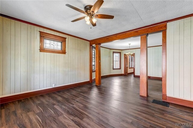 373 Urban St, Buffalo, NY 14211 - empty room featuring ornamental molding, plenty of natural light, a textured ceiling, ceiling fan, and dark wood finished floors