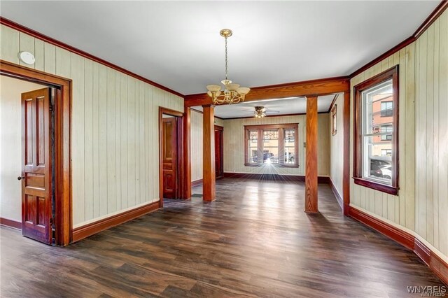 373 Urban St, Buffalo, NY 14211 - unfurnished dining area featuring crown molding, a chandelier, dark wood-style flooring, and wood walls