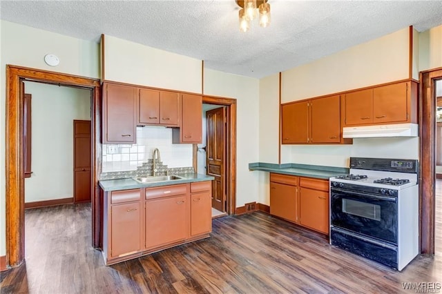 373 Urban St, Buffalo, NY 14211 - kitchen with range with gas cooktop, under cabinet range hood, dark wood-style floors, a textured ceiling, and decorative backsplash
