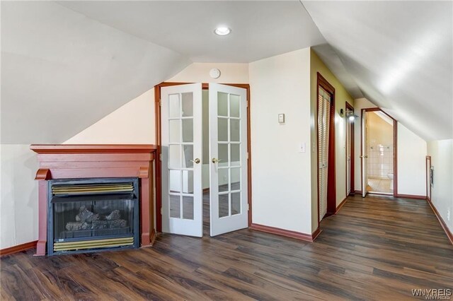 373 Urban St, Buffalo, NY 14211 - unfurnished living room with wood finished floors, vaulted ceiling, a glass covered fireplace, and french doors