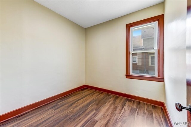 373 Urban St, Buffalo, NY 14211 - spare room featuring baseboards and dark wood-type flooring