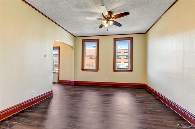 373 Urban St, Buffalo, NY 14211 - unfurnished room featuring ornamental molding, dark wood-style floors, arched walkways, ceiling fan, and a textured ceiling