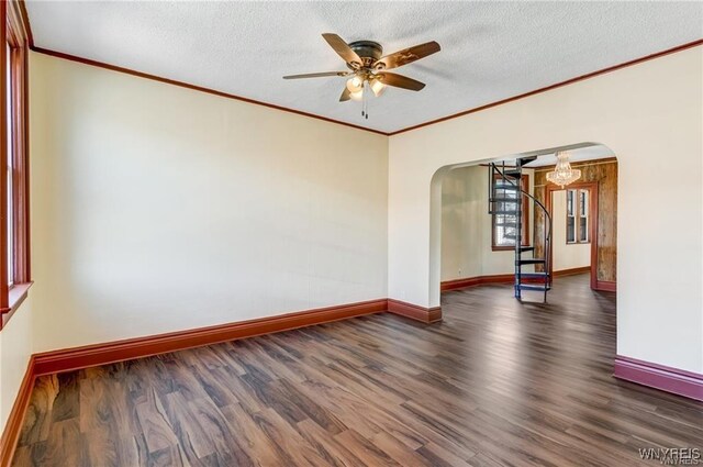 373 Urban St, Buffalo, NY 14211 - empty room with arched walkways, ceiling fan, wood finished floors, ornamental molding, and a textured ceiling