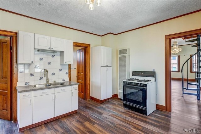 373 Urban St, Buffalo, NY 14211 - kitchen featuring gas stove, dark wood finished floors, white cabinets, ornamental molding, and backsplash
