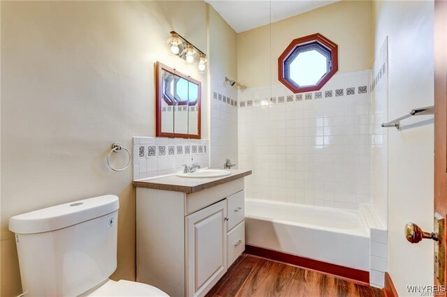 373 Urban St, Buffalo, NY 14211 - bathroom with vanity, wood finished floors, and bathtub / shower combination