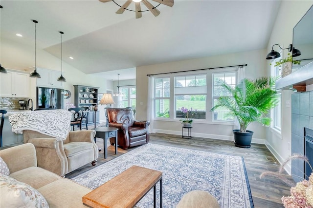 1391 Creeks Edge Dr, Webster, NY 14580 - living area featuring lofted ceiling, a tiled fireplace, wood finished floors, and a ceiling fan
