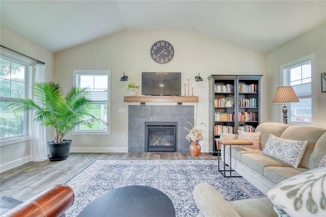 1391 Creeks Edge Dr, Webster, NY 14580 - living area with wood finished floors, lofted ceiling, and a tile fireplace