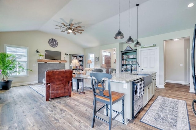 1391 Creeks Edge Dr, Webster, NY 14580 - kitchen featuring dishwasher, healthy amount of natural light, vaulted ceiling, a ceiling fan, and light wood-type flooring