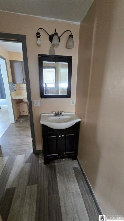 708 Grant Ave, Dunkirk-City, NY 14048 - bathroom featuring wood finished floors and vanity